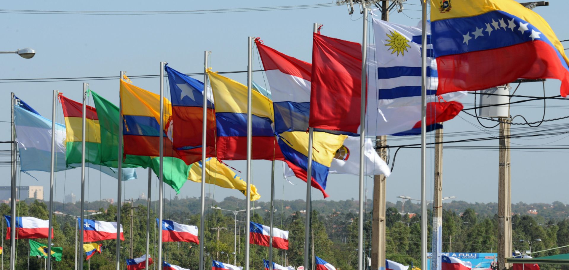 Flags of the countries that are full and associate members of Mercosur, the South American trade bloc. Political changes and recession in Argentina and Brazil have pushed the group to try to liberalize its trade policies.