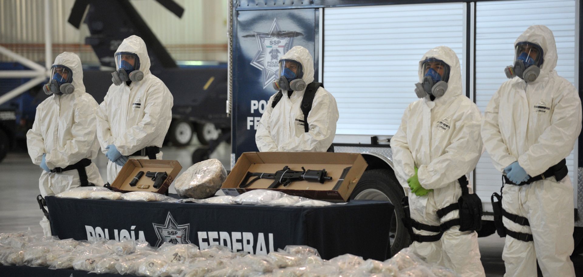 Mexican police shows off seized drugs and weapon to member of the media on February 14, 2012, in Mexico City. 
