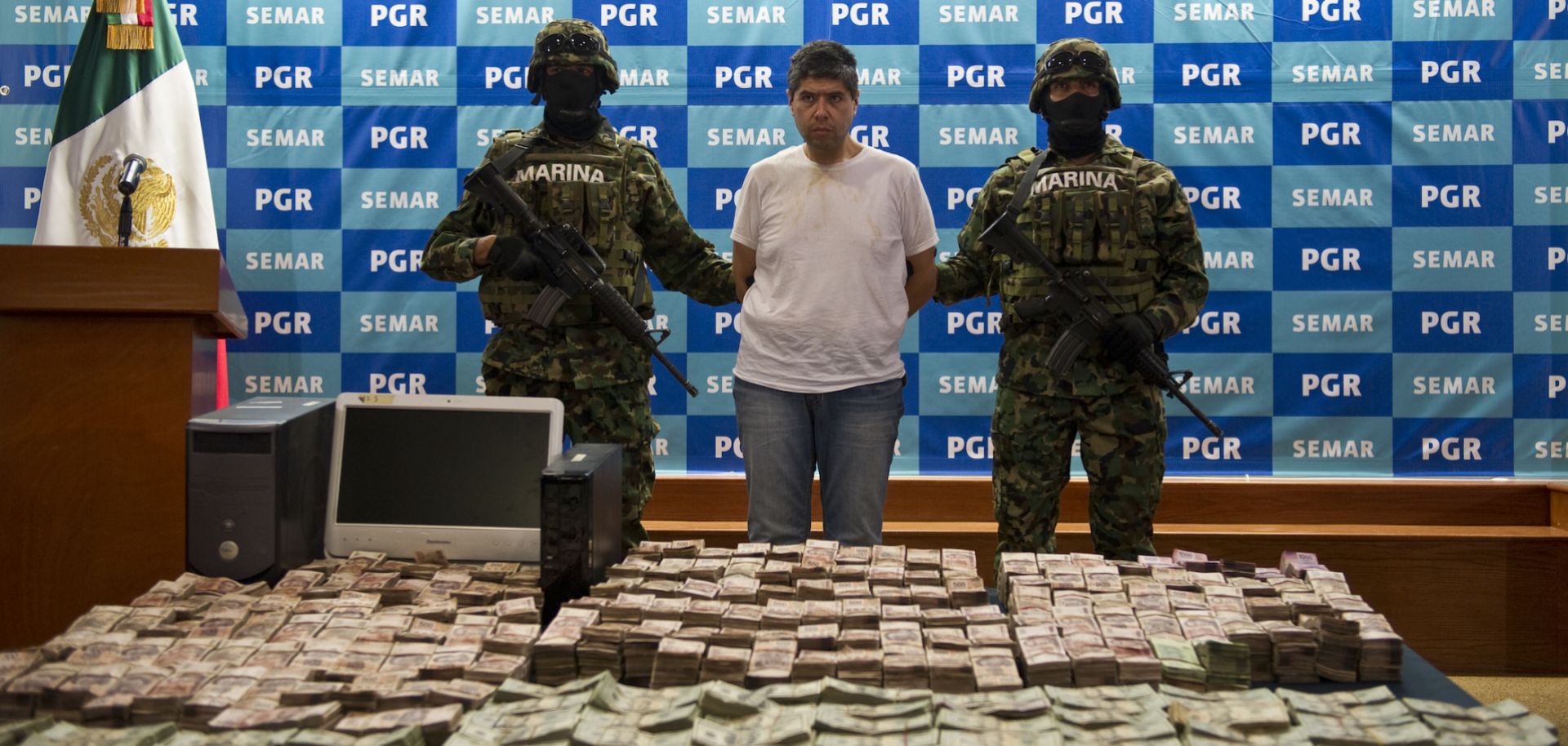 An alleged member of the Zetas drug cartel and money seized during his arrest