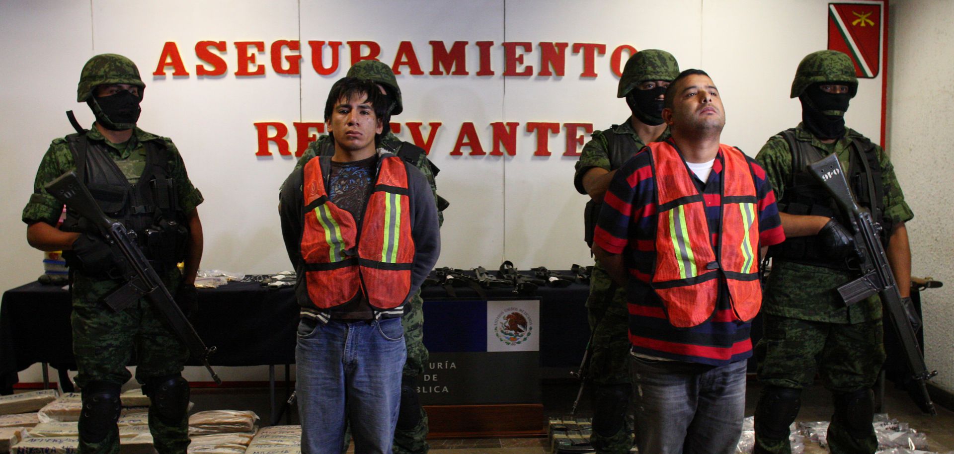 Mexican soldiers escort Oscar Pozos Jimenez (L) and Jose Serna Padilla, an alleged member of the Cartel de Jalisco Nueva Generacion, in Guadalajara on March 18, 2012.