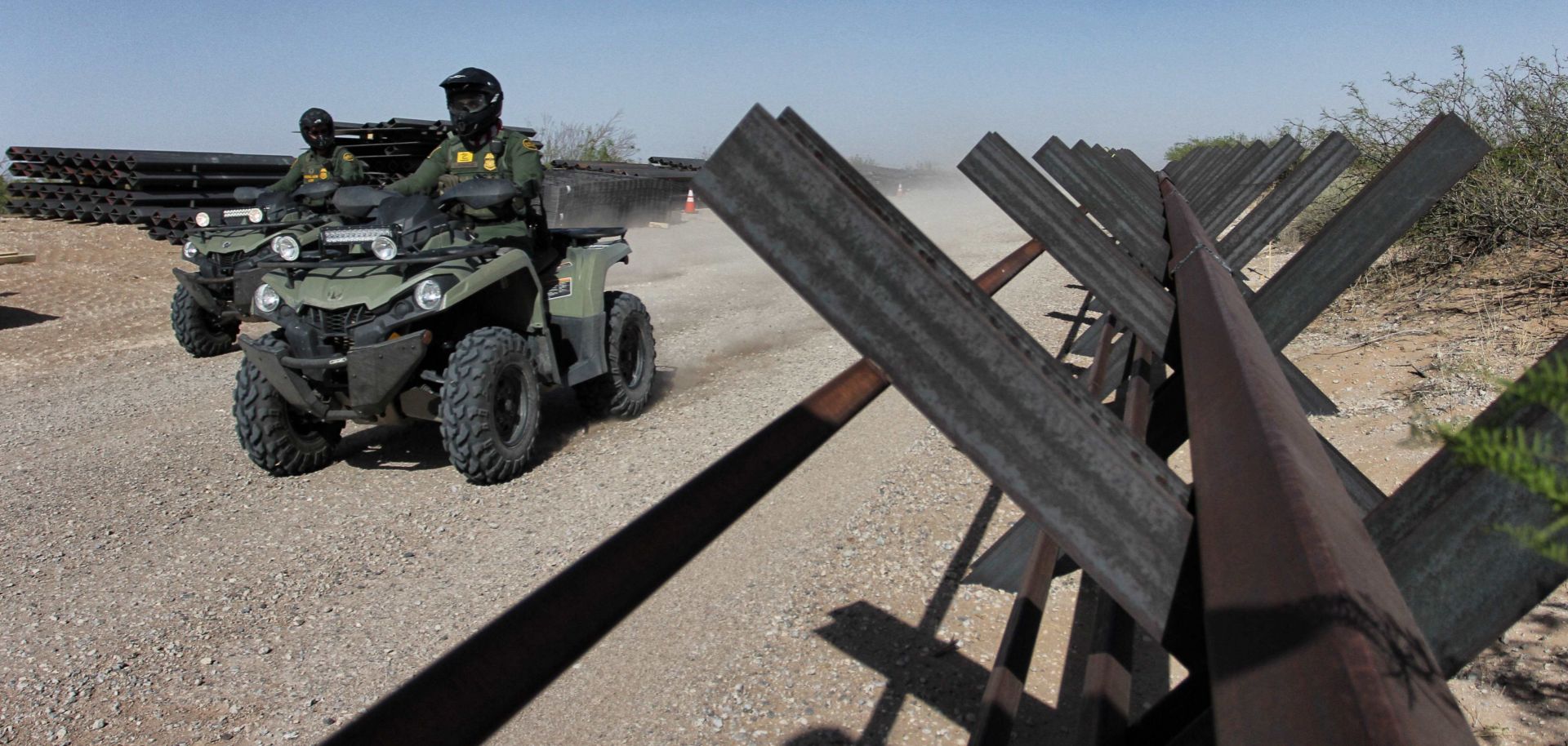 U.S. Border Patrol agents ride ATVs alongside an unfinished portion of a border wall between Ciudad Juarez in Mexico and Santa Teresa in the United States on April 17, 2018.