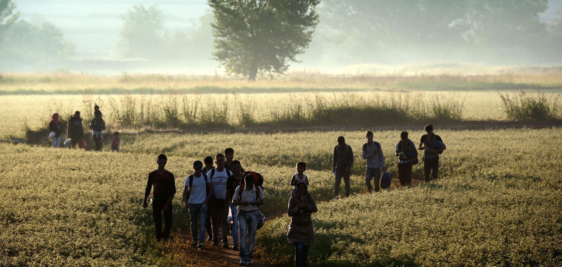 Immigrants cross the border from Greece to Macedonia on Aug. 29, 2015. 