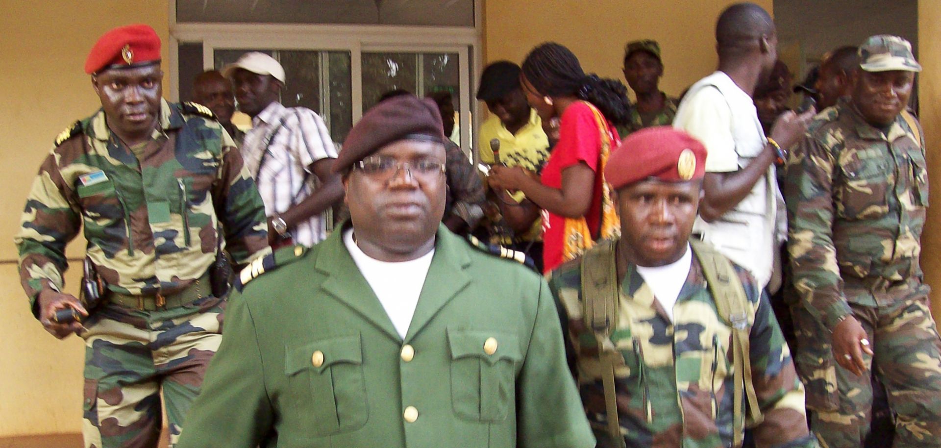 Military spokesman Dabana na Walna (C) of Guinea-Bissau walks with soldiers.