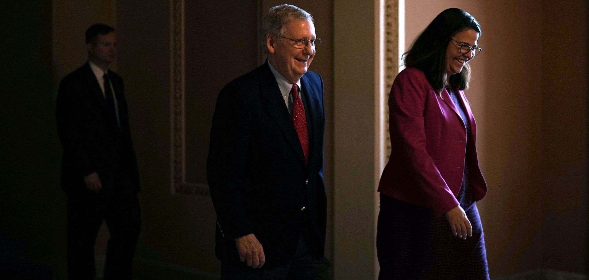 U.S. Senate Majority Leader Mitch McConnell, left, and an aide walk toward the Senate chamber in the U.S. Capitol on Feb. 12, 2018.