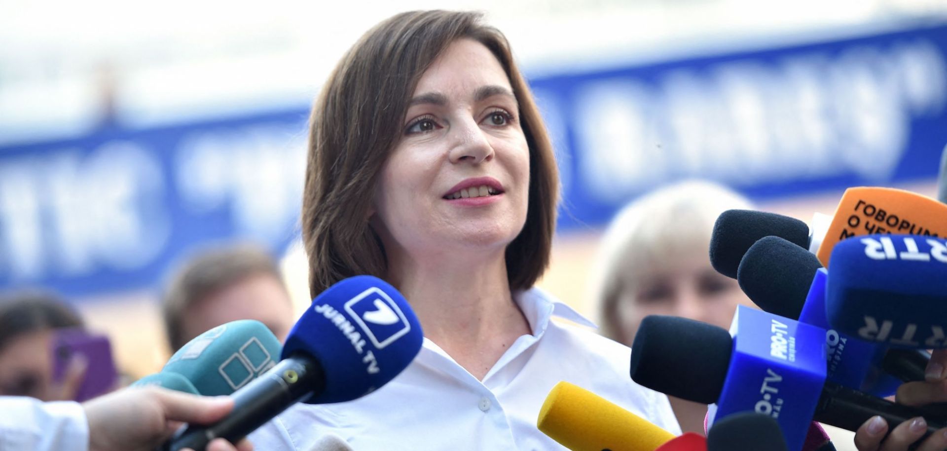 Moldovan President Maia Sandu speaks with journalists outside a polling station in Chisinau on July 11, 2021. 