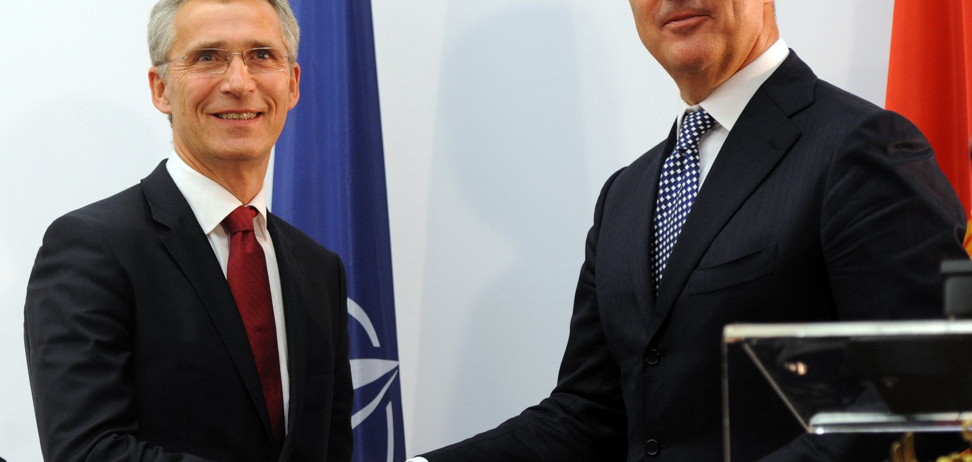 Montenegro's Prime Minister Milo Djukanovic shakes hands with NATO Secretary General Jens Stoltenberg.
