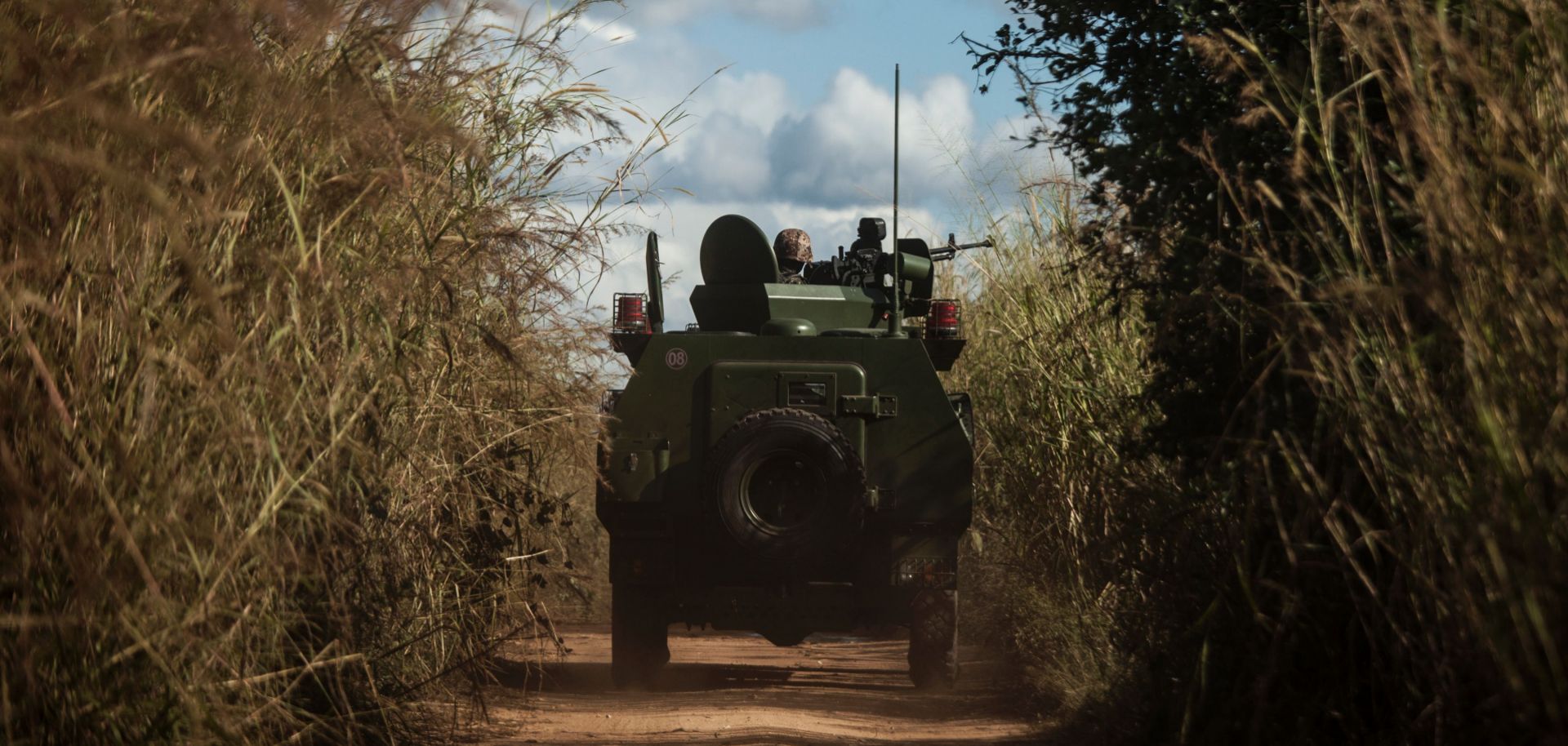 Army vehicles patrol the roads on the outskirts of a village in northern Mozambique on May 26, 2016. 