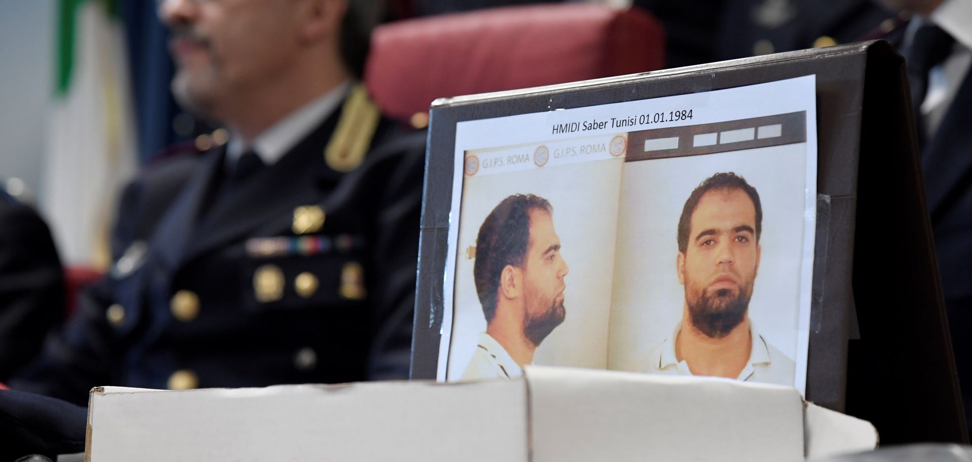 The mugshot of Hmidi Saber, a suspected member of Ansar al-Sharia is displayed at a press conference.