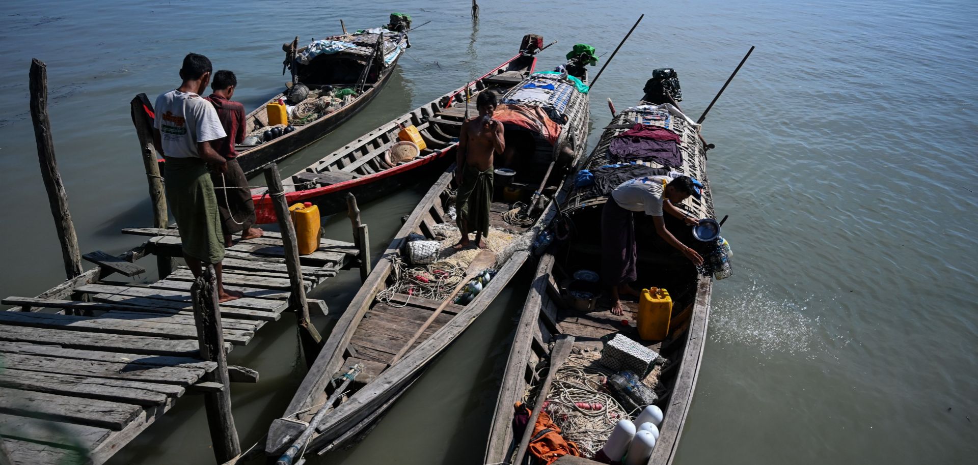 This photo taken on Oct. 2, 2019, shows fishermen boarding their boats at a small jetty on Made Island off Kyaukphyu in Myanmar's Rakhine state.