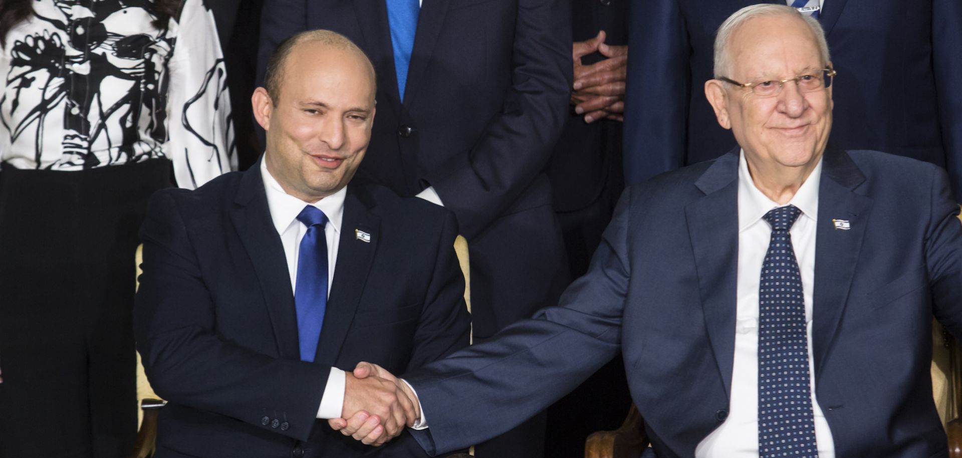 Israeli President Reuven Rivlin shakes hands with Prime Minister Naftali Bennett during the official swearing-in of Israel’s new government on June 14, 2021. 