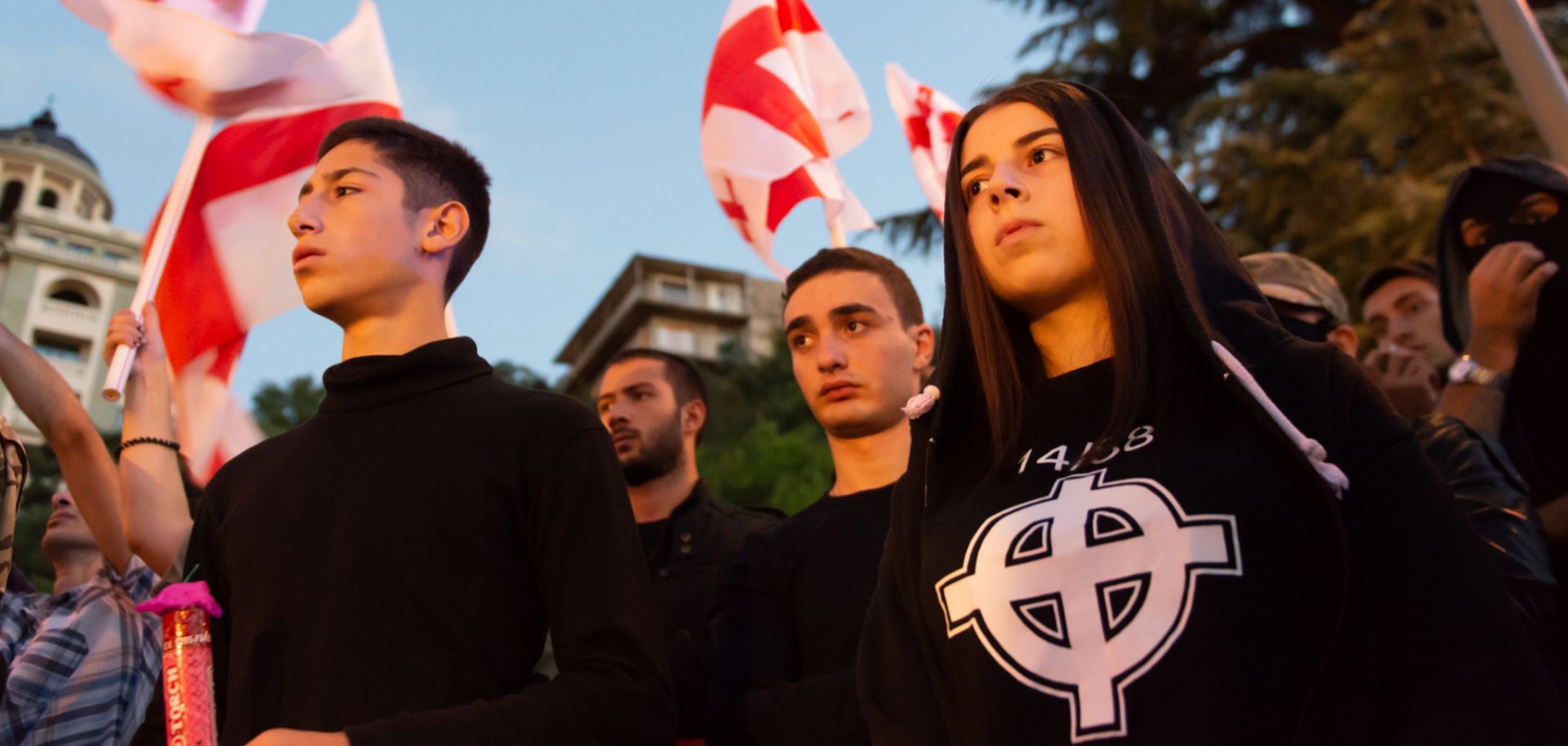 A young Georgian, right, wears a T-shirt with the Stormfront logo and the number 14/88 during a September 2016 rally. The number 14 denotes David Lane’s 14-word white supremacist mantra while 88, as the eighth letter of the alphabet, signifies HH, which stands for Heil Hitler.
