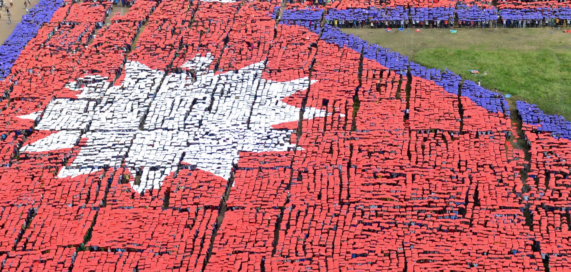 An aerial view of the Nepalese national flag formed by more than 35,000 people Aug. 23, 2014, in central Kathmandu, Nepal.