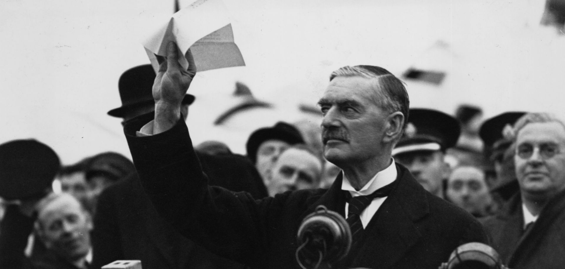 British Prime Minister Neville Chamberlain arrives at Heston airport outside London in 1938 with the Munich Pact he and Germany's Adolf Hitler signed.