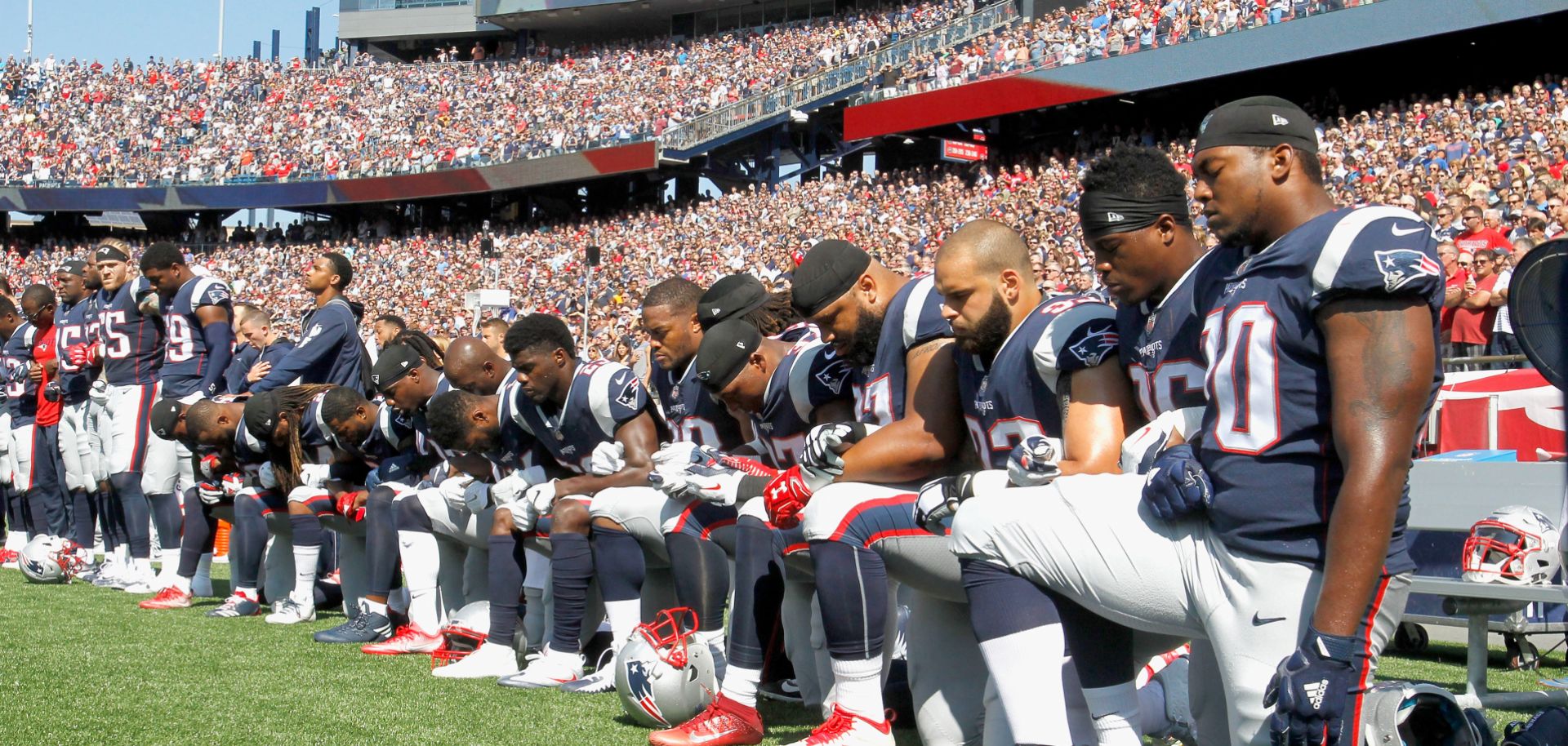 Members of the New England Patriots kneel during the national anthem before a game in Massachusetts. 