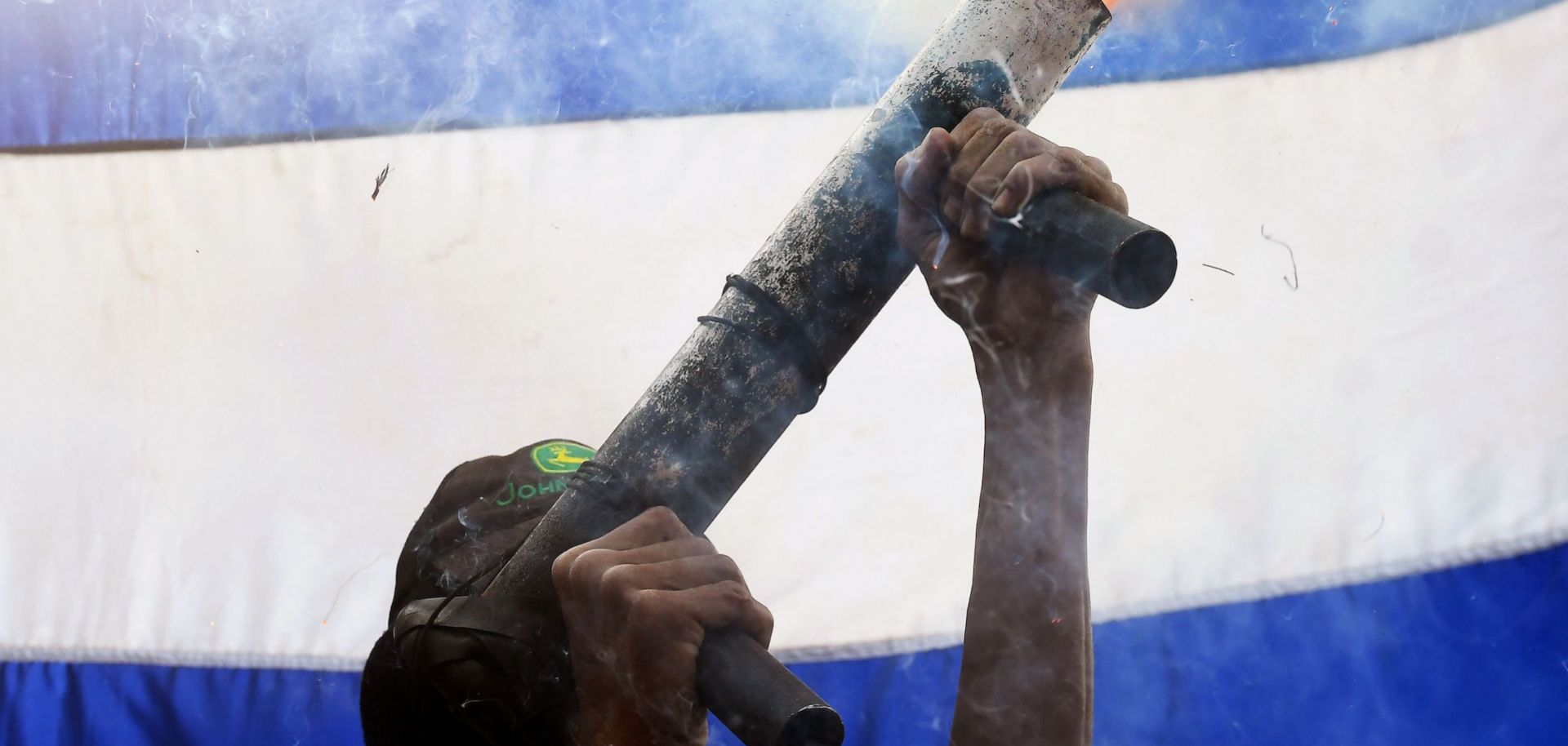 A protester with the April 19th movement in Masaya, Nicaragua, fires a homemade mortar into the air on June 18, 2018.