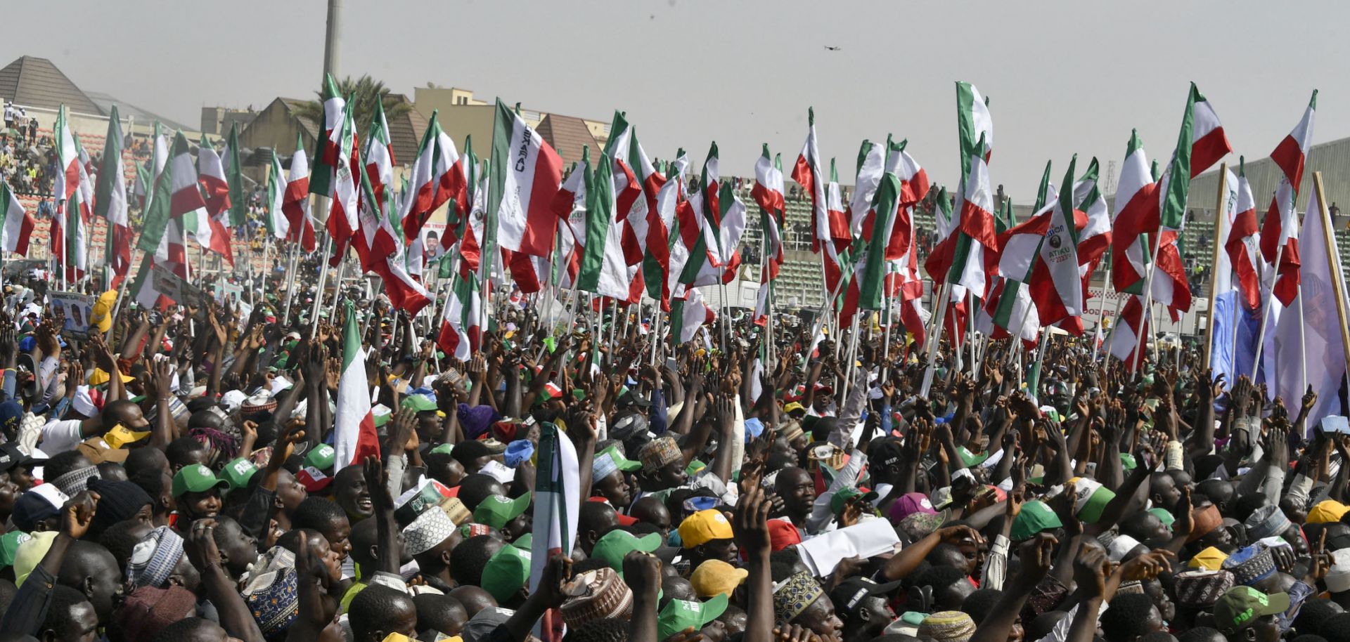 Supporters hold flags to support opposition PDP candidate Atiku Abubakar during a campaign rally in Kano state in northwestern Nigeria on Feb. 9, 2023.