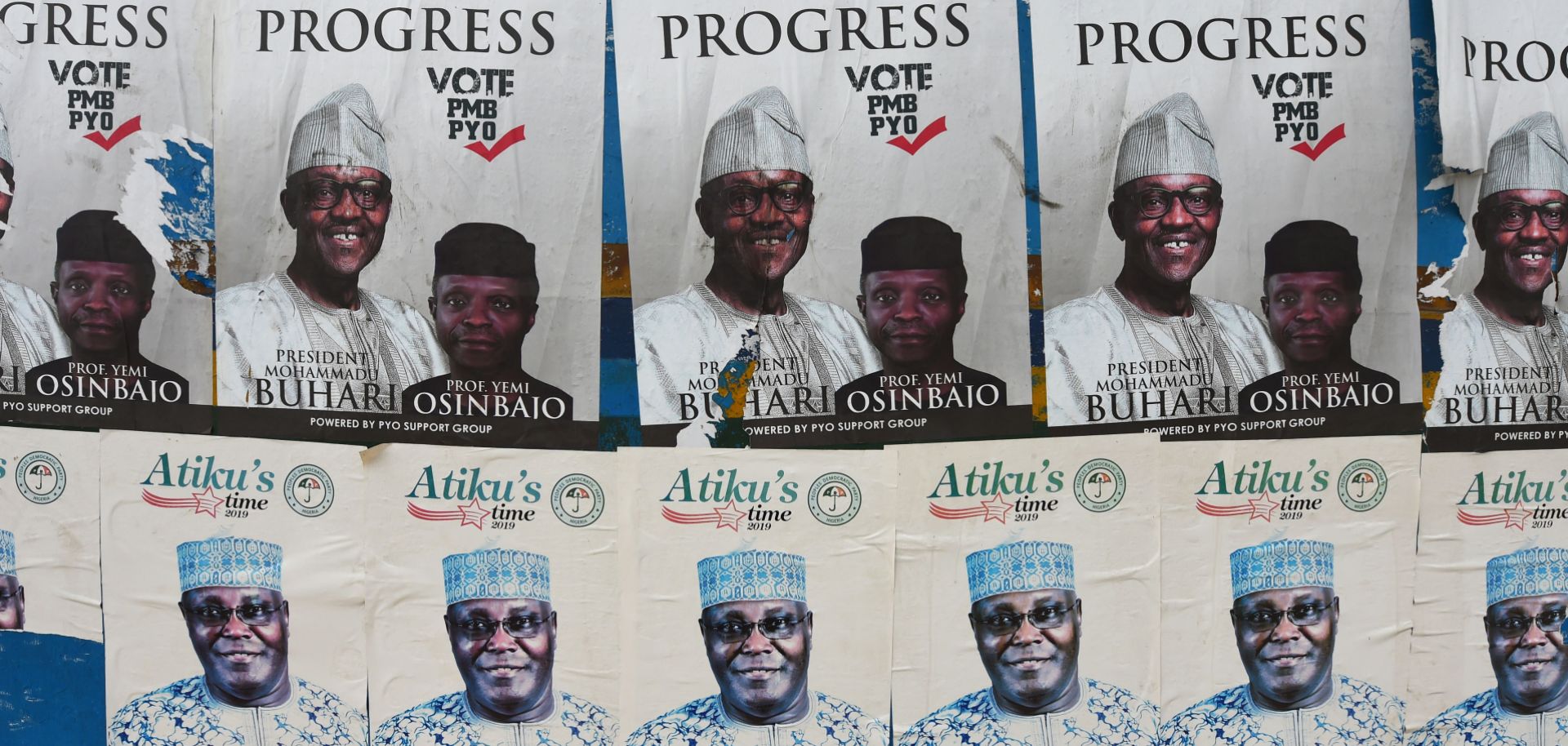 Side-by-side campaign posters line a bus stop for President Muhammad Buhari and his challenger, Atiku Abubakar, ahead of the presidential election on Feb. 16. 
