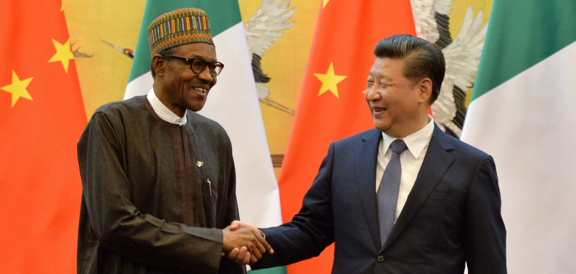 Nigerian President Muhammadu Buhari (L) shakes hands with his Chinese counterpart, Xi Jinping, in Beijing.