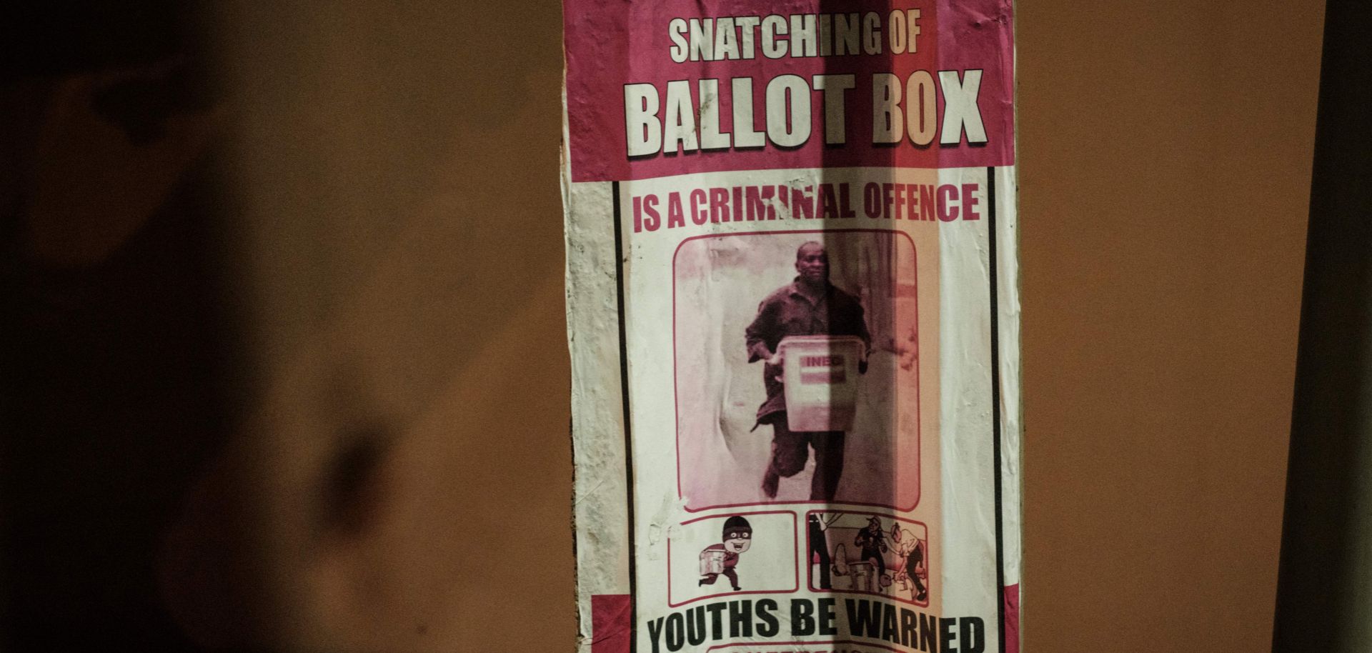 A warning poster is shown in Lagos, Nigeria, ahead of presidential and legislative elections on Feb. 16.