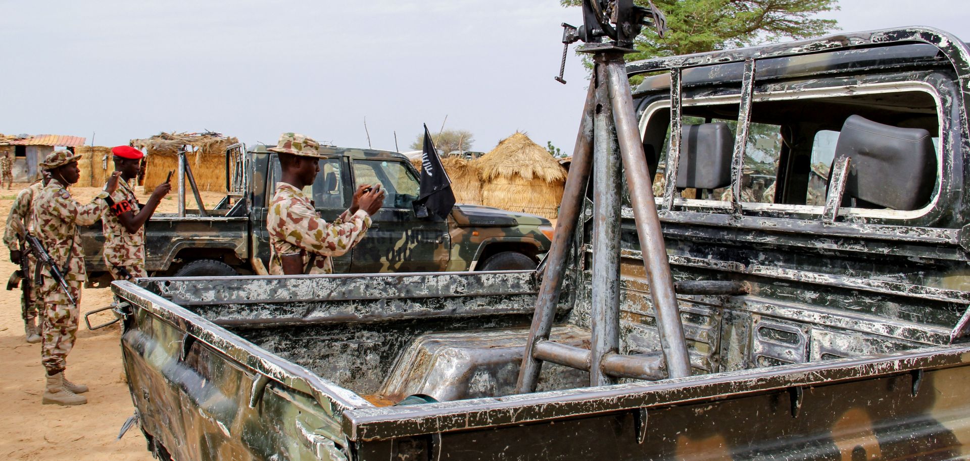 Soldiers take snapshots of vehicles allegedly belonging to ISWAP in Baga, Nigeria, on Aug. 2, 2019.