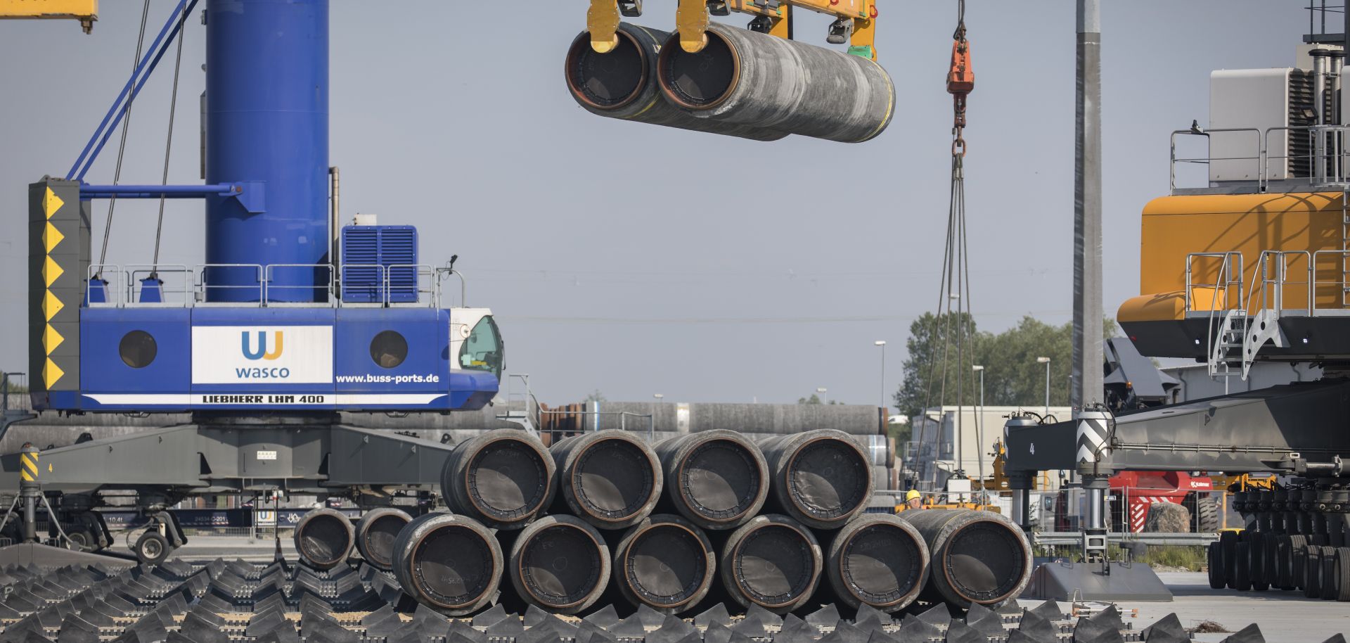 A crane moves Nord Stream 2 pipes at a port near Sassnitz, Germany, on June 5, 2019. 
