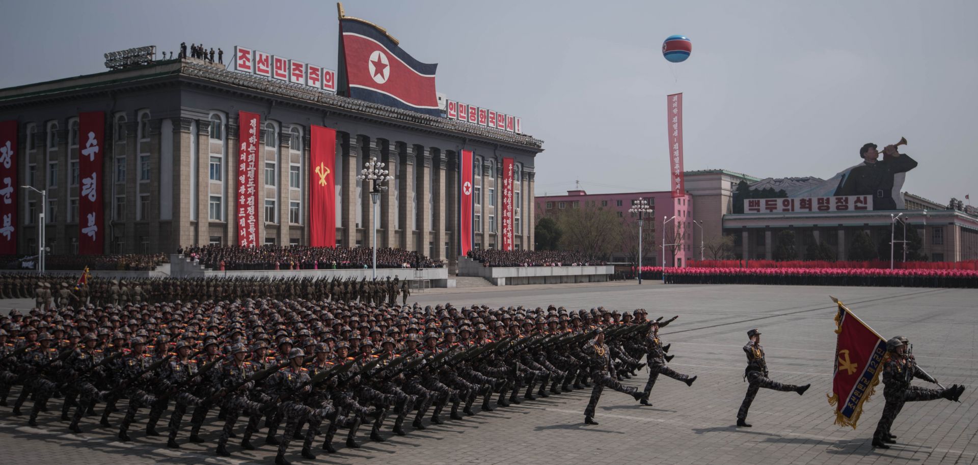 A military parade marches past buildings in North Korea's capital, Pyongyang. 