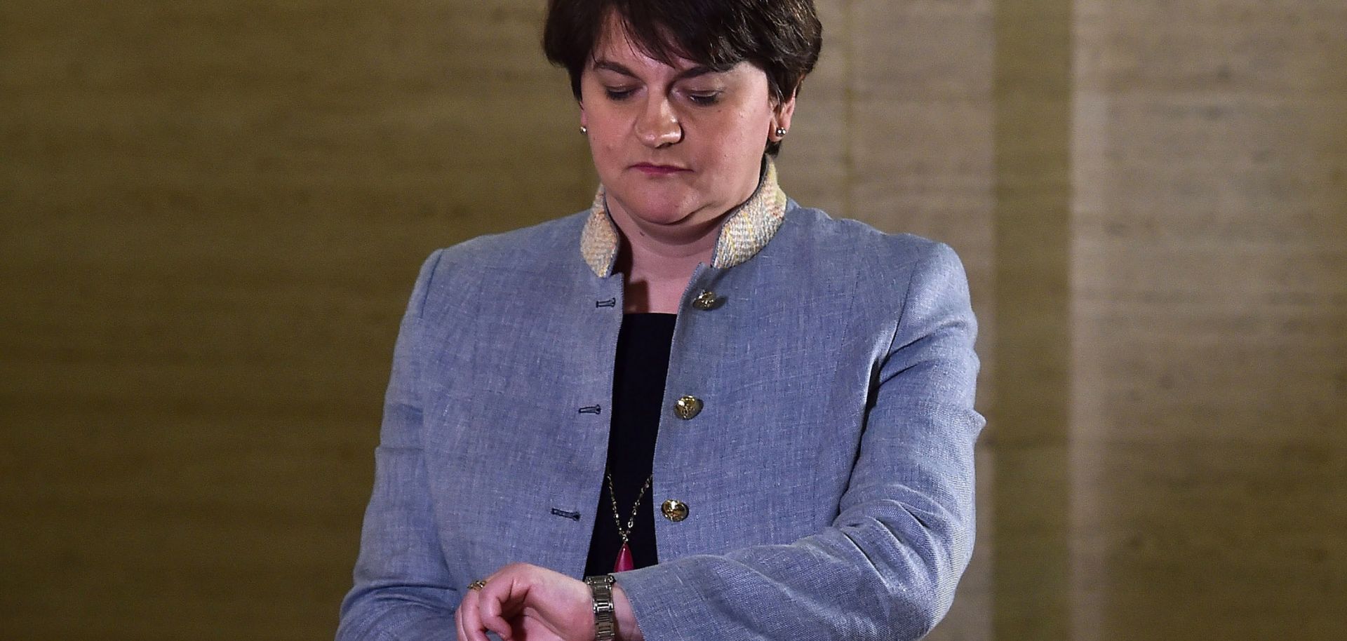 Northern Ireland’s first minister and leader of the Democratic Unionist Party (DUP), Arlene Foster, looks at her watch outside the Parliament Buildings in Belfast.