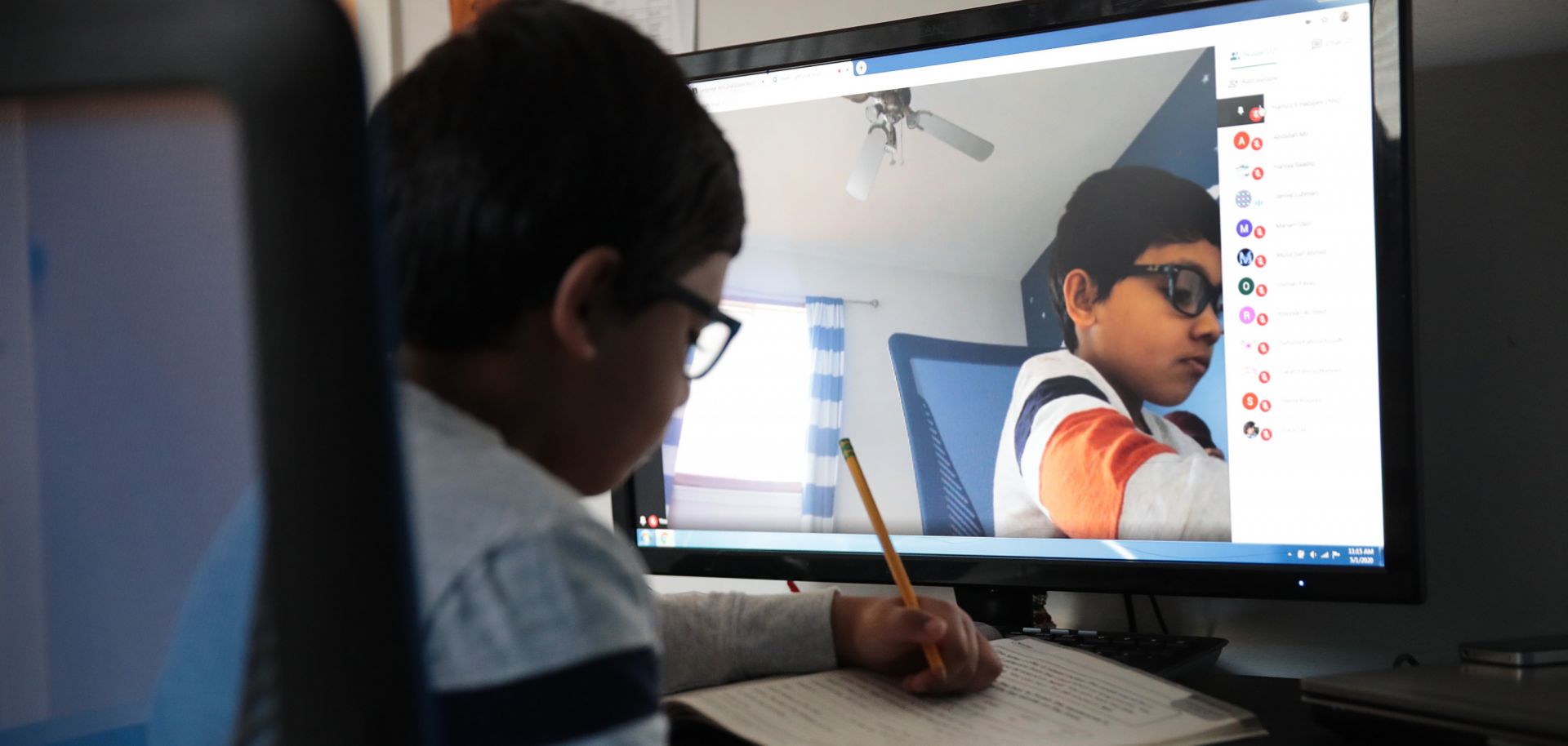 Seven-year-old Hamza Haqqani, a 2nd grade student at Al-Huda Academy, uses a computer to participate in an online class with his teacher and classmates at his home in Bartlett, Illinois, on May 1, 2020. Al-Huda Academy has had to adopt an e-learning program to finish the year after all schools in the state were forced to cancel classes to curb the spread of COVID-19.