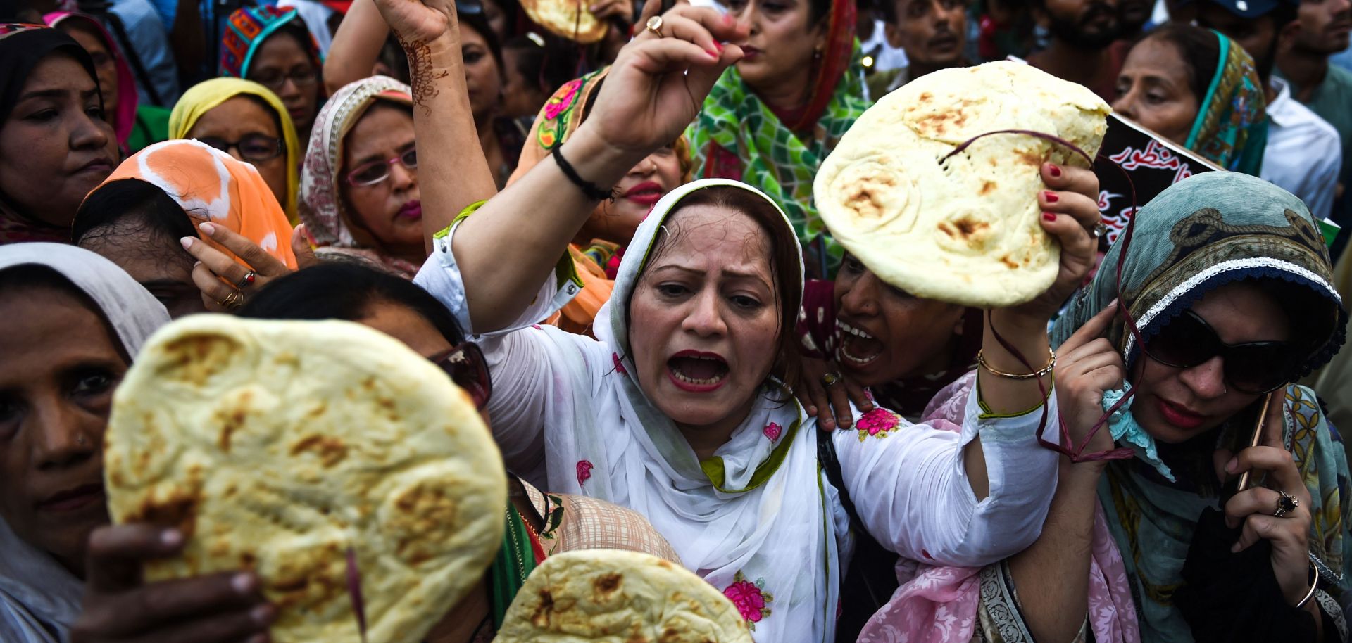Activists from the Pakistan People's Party hold bread aloft in a protest against Prime Minister Imran Khan's government budget on June 23, 2019, in the southern city of Karachi.