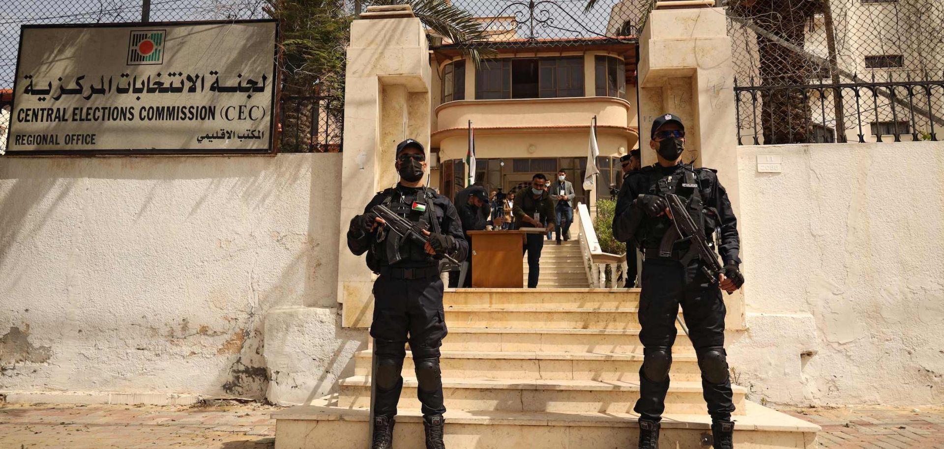 Police officers stand guard March 20, 2021, outside the Central Elections Commission office in Gaza City at the start of the registration period for the May parliamentary election.