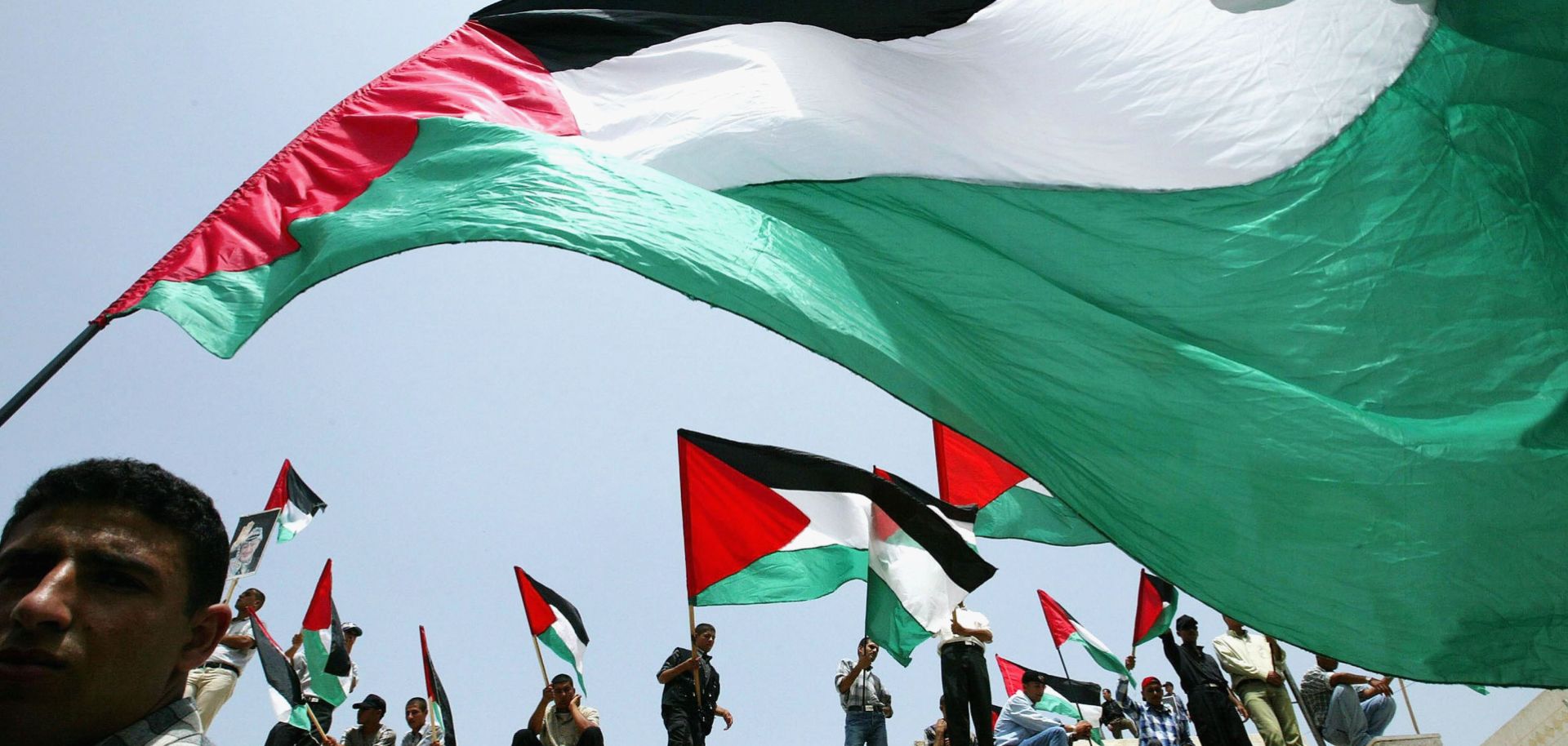 Relatives of Palestinian prisoners being held in Israeli jails wave their national flags as they attend a rally, calling for their release in 2003 in Gaza City, the Gaza Strip.