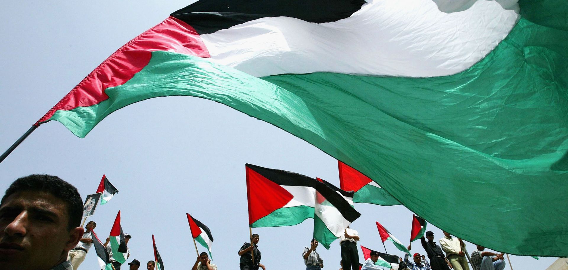 Relatives of Palestinian prisoners being held in Israeli jails wave their national flags as they attend a rally, calling for their release in 2003 in Gaza City, the Gaza Strip.