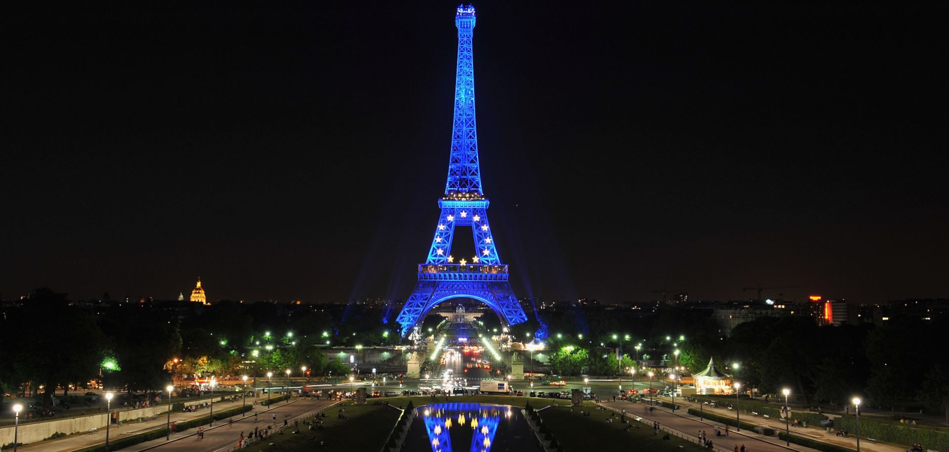 The Eiffel tower is lit with symbols of the European Union, including the stars and blue color that make up the bloc's flag. 