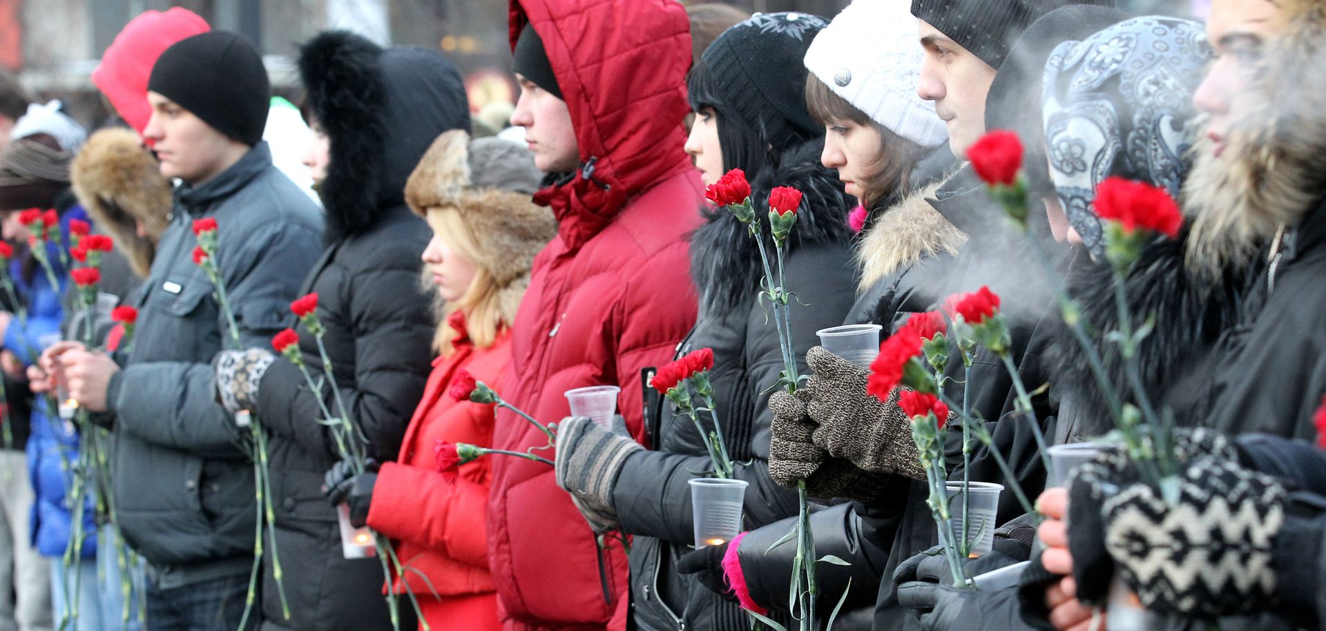 People hold flowers in central Moscow.