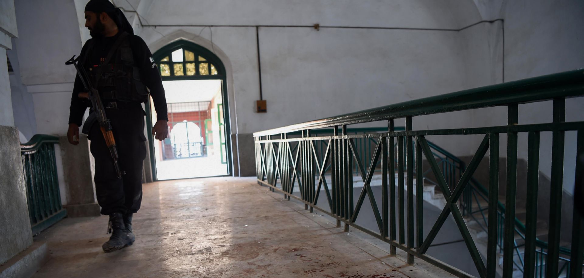 A policeman responds to a Dec. 1 terrorist attack at the Agricultural Training Institute in Peshawar, Pakistan, capital of Khyber-Pakhtunkhwa province.