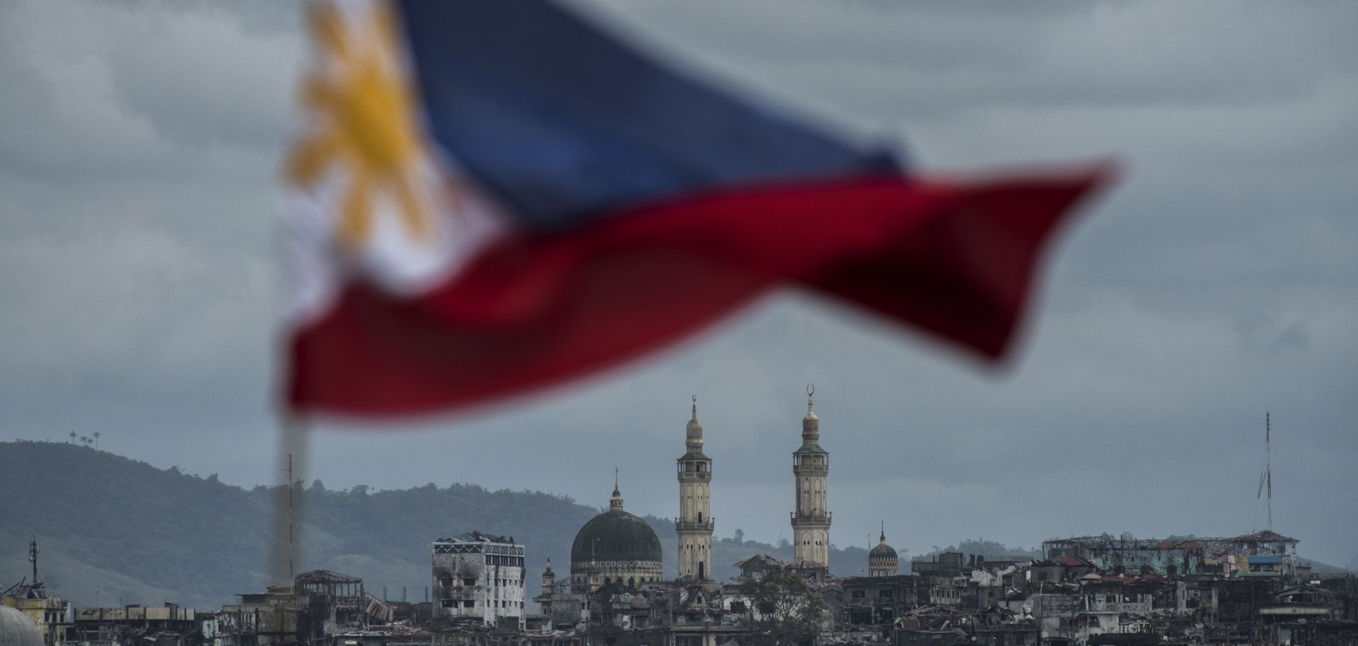The Philippine flag is seen waving over the besieged city of Marawi.