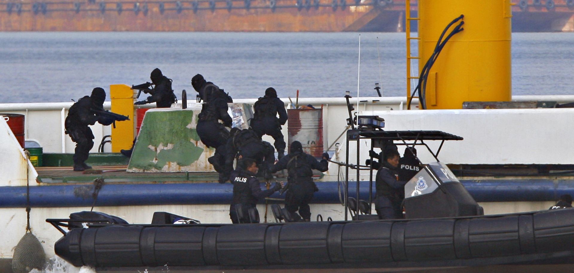 Royal Malaysian Police Special Forces personnel storm a mock hijacked ship during an anti-piracy demonstration exercise June 13, 2007, in Port Klang, Malaysia.