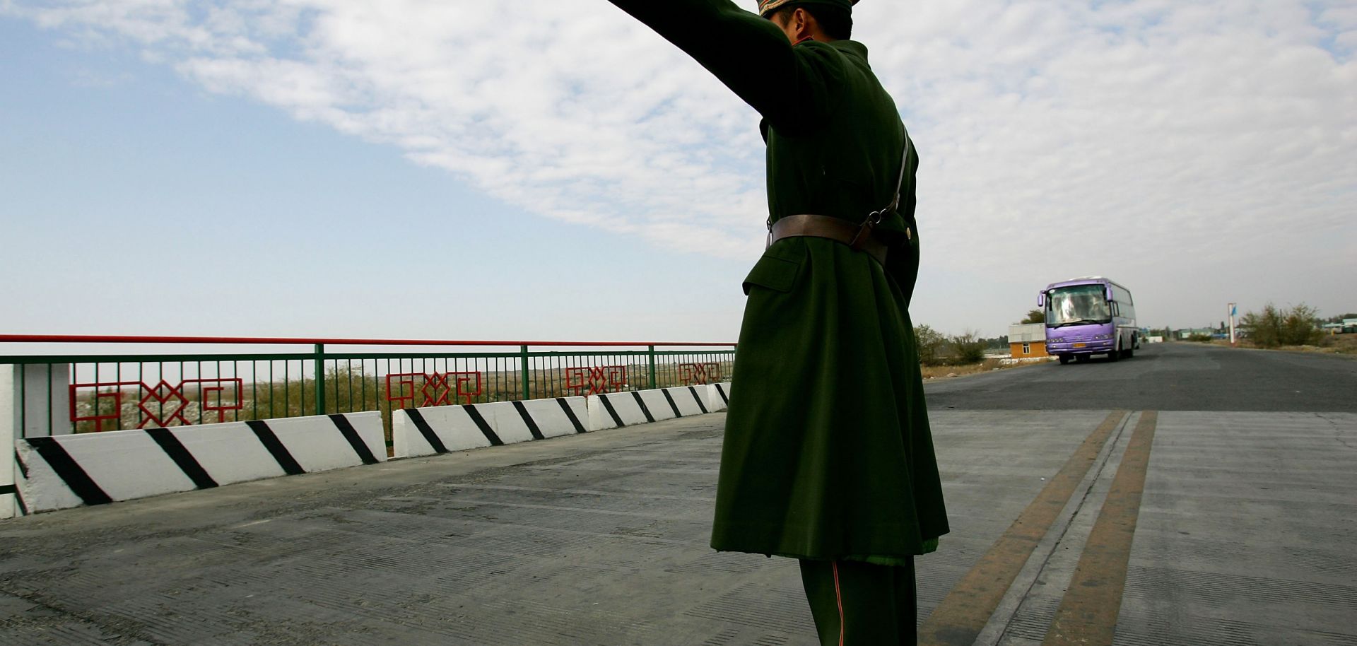 A police officer points the way for a bus at Horgas land port.