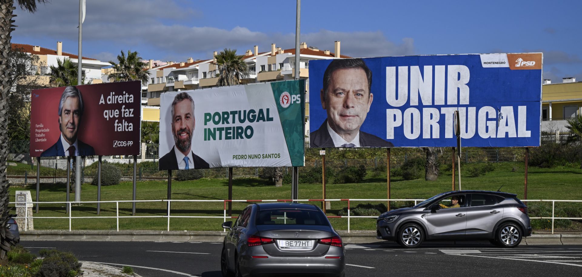 A photo taken on Jan. 20, 2024, shows cars driving by campaign billboard posters in Sao Pedro do Estoril, Portugal, ahead of the country's March 10 parliamentary elections. 