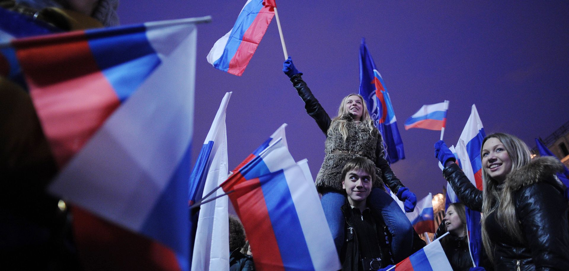 Activisits from the pro-Kremlin youth groups celebrate the victory of the United Russia party.