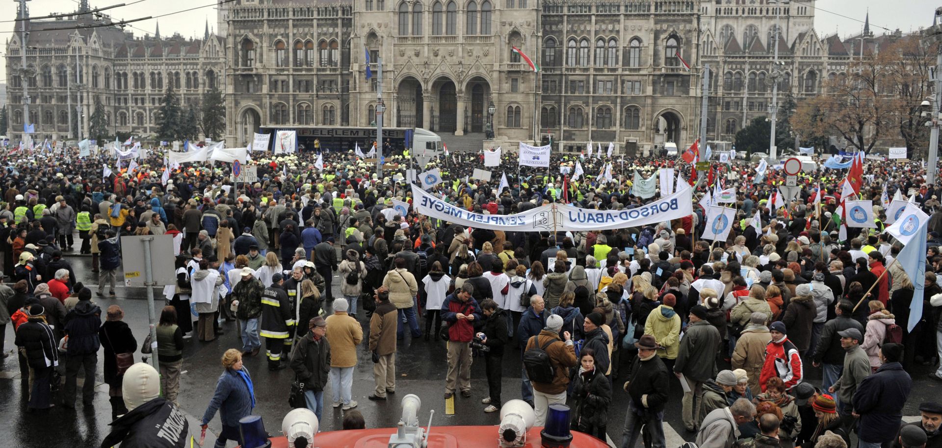 Public sector employees stand in the pouring rain to protest against planned government austerity measures. 