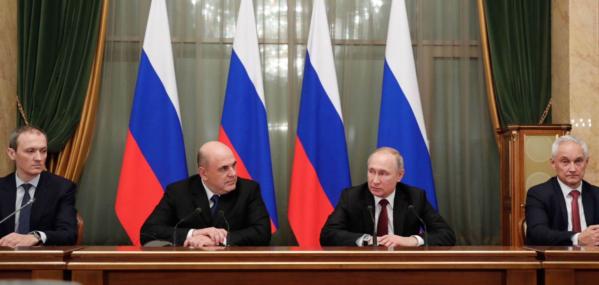 Russian President Vladimir Putin (2R) and Prime Minister Mikhail Mishustin (2L) meet with members of the new government in Moscow on Jan. 21, 2020.