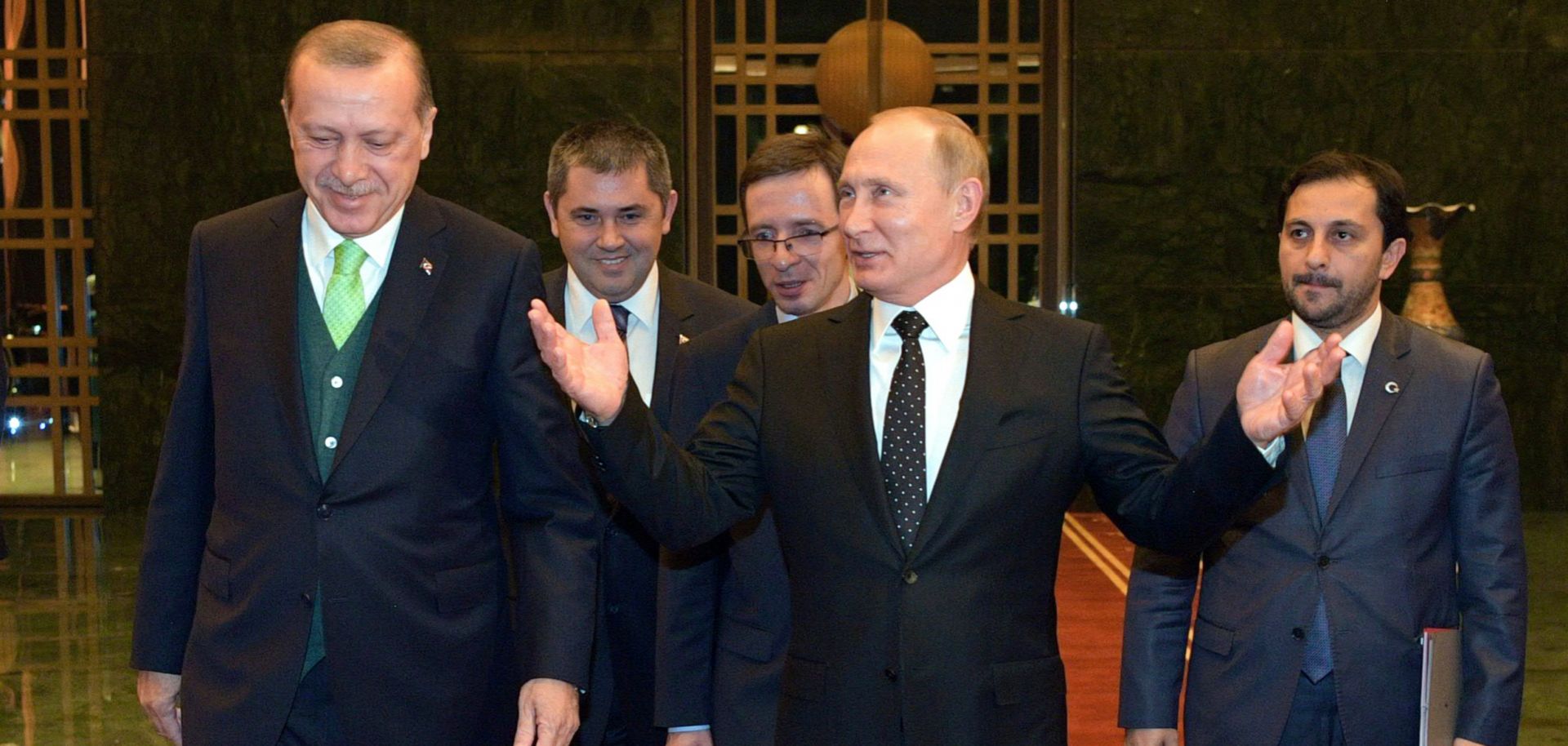 Turkey's president, Recep Tayyip Erdogan, left, welcomes Russian President Vladimir Putin, center, to Ankara on Dec. 11.