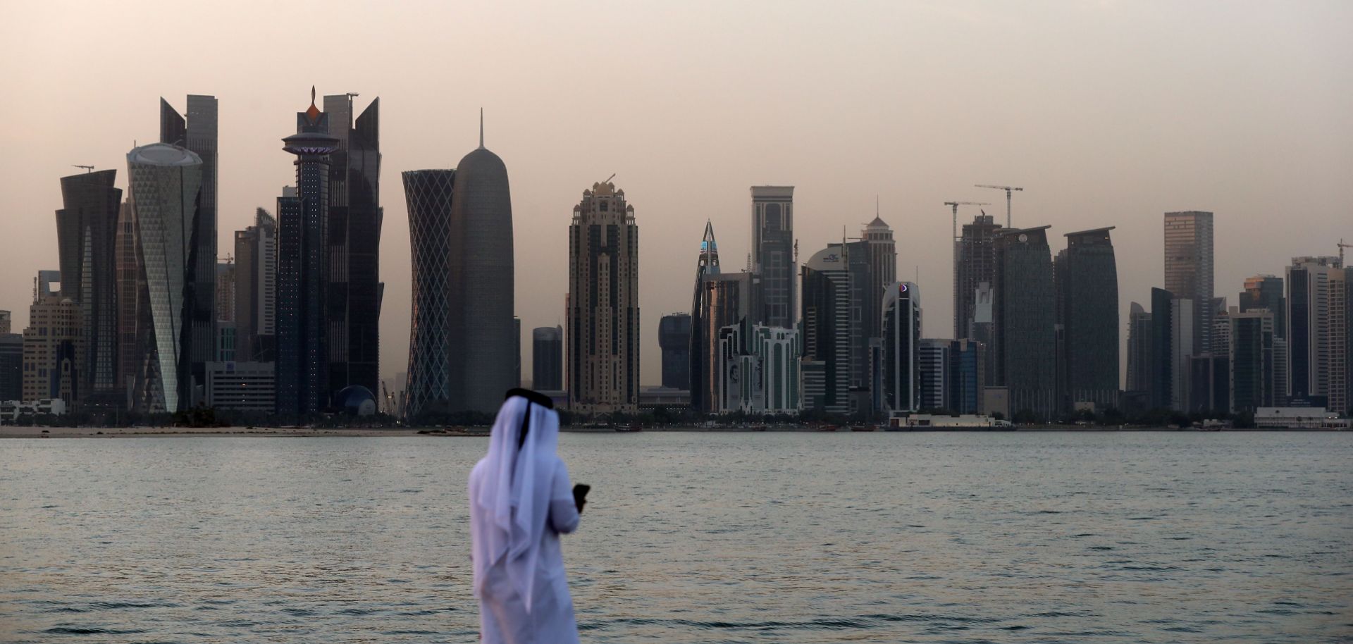 A man faces the skyline of Doha, Qatar's capital.