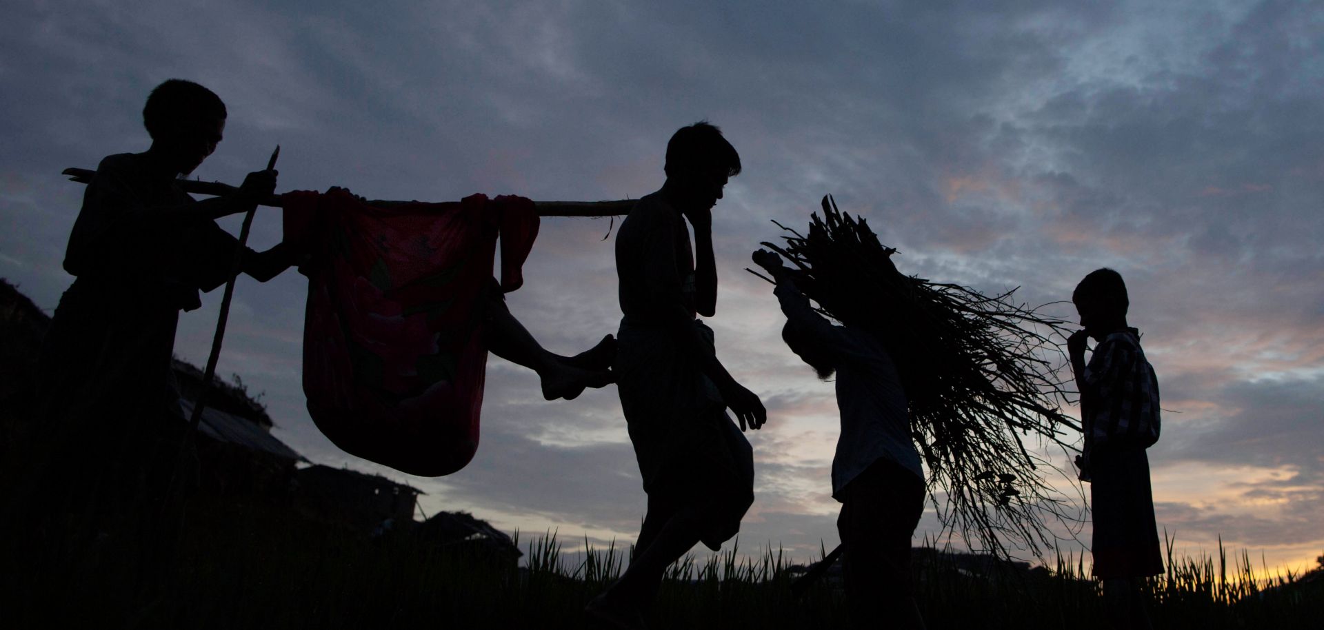 Rohingya refugees walk through a camp in Bangladesh after arriving from Myanmar.