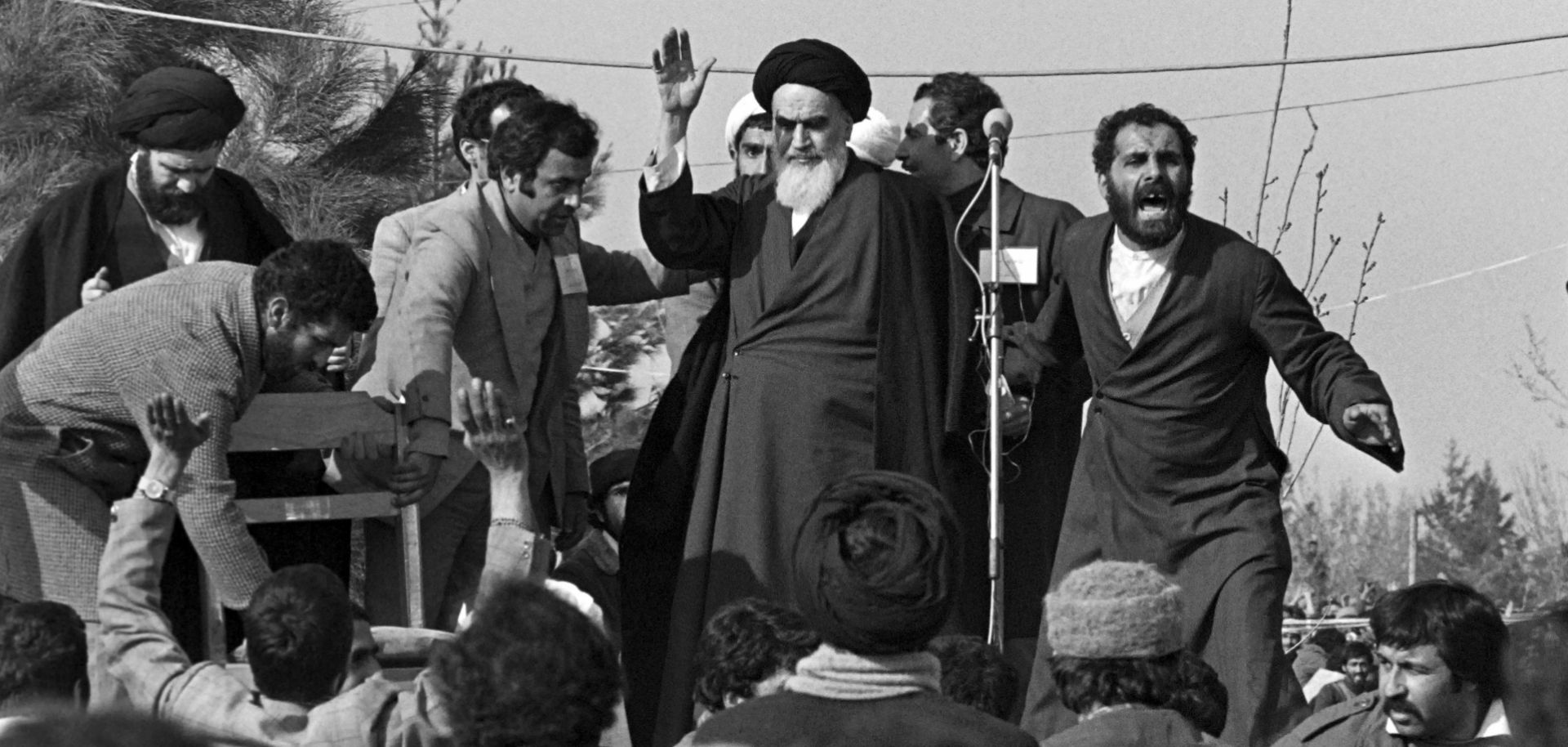 In this 1979 file image, Ayatollah Ruhollah Khomeini waves to supporters during his return to Tehran from exile in France.