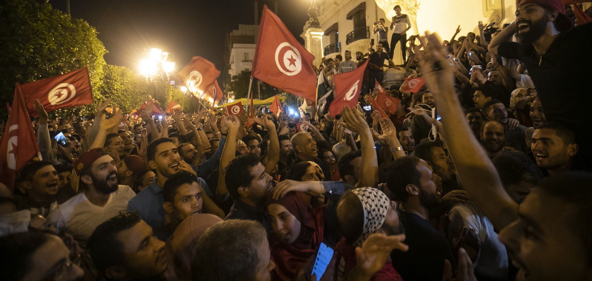 In this photo, Tunisians celebrate Kais Saied's victory in Tunisia's presidential election on Oct. 13, 2019.