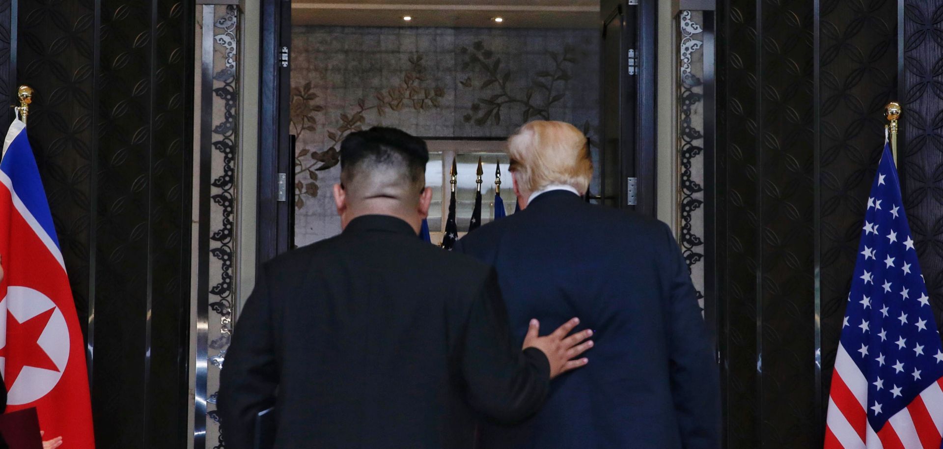 North Korean leader Kim Jong Un follows U.S. President Donald Trump into Singapore's Capella Hotel for their summit June 12.