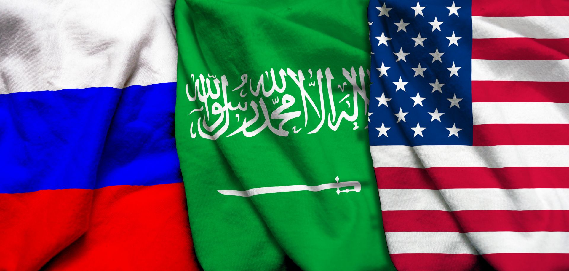 An impage shows the Russian, Saudi Arabian and U.S. flags from left to right. 