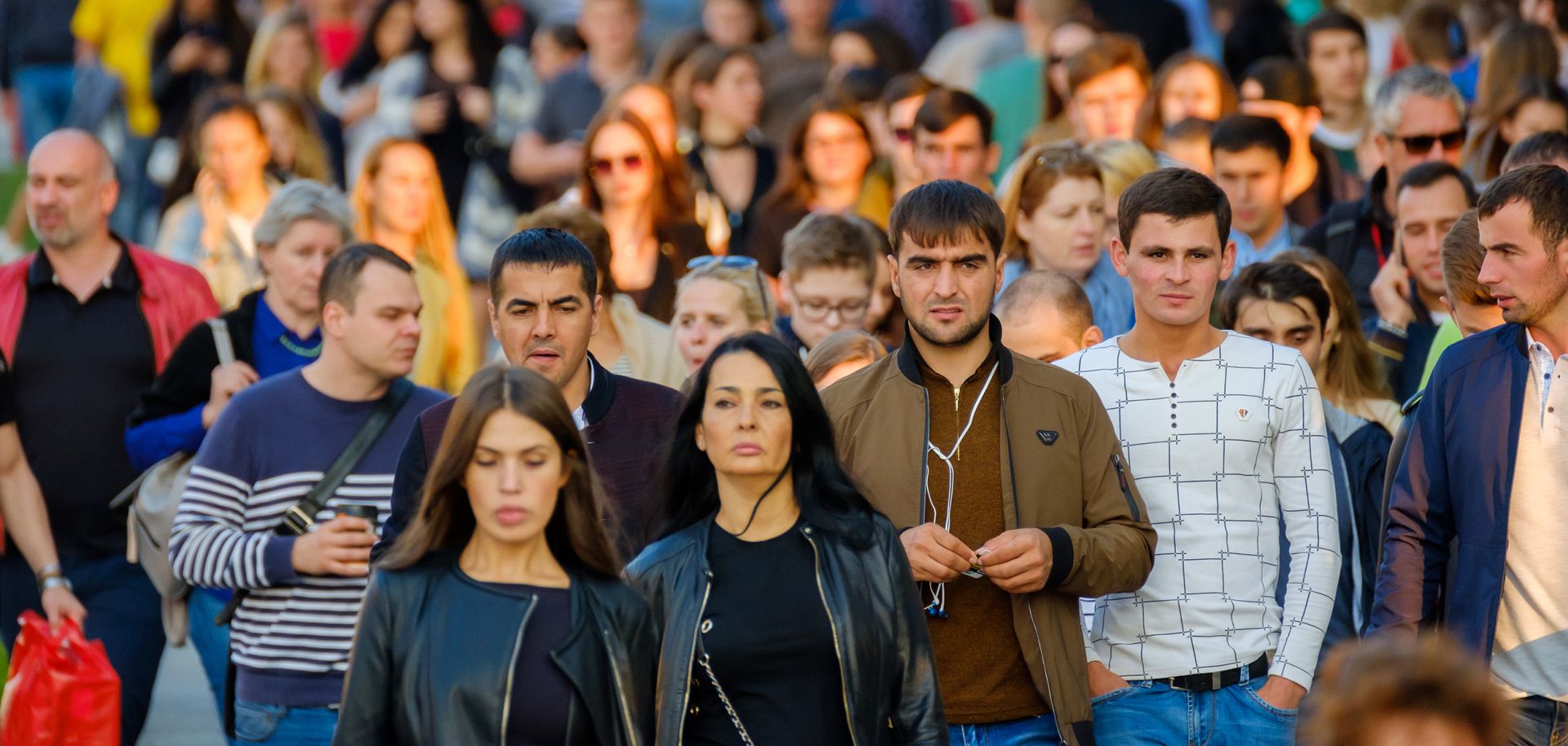 A crowd of people walks down the street in Moscow in September 2017.